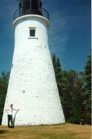 Juan holding up the Presque Isle lighthouse